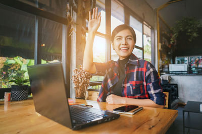 Man working on table in cafe