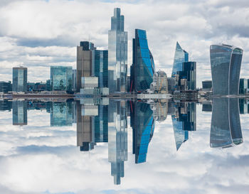 Modern buildings against cloudy sky