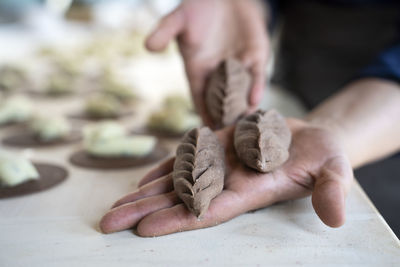 Midsection of person holding seashell