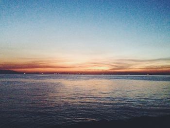 Scenic view of sea against sky at sunset