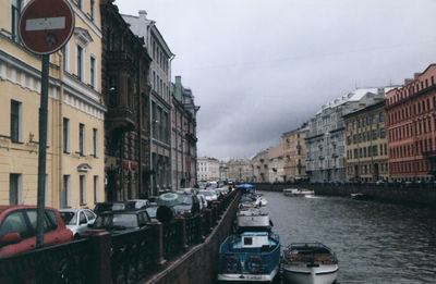 Boats in canal along buildings