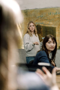 Female business people discussing while working in office