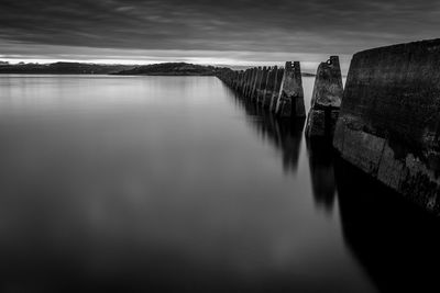 Scenic view of river against cloudy sky