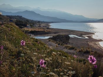 Scenic view of sea and mountains against sky