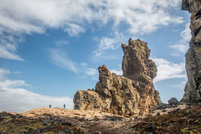 Low angle view of rock formation against sky