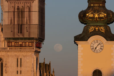 Low angle view of clock tower against sky in city