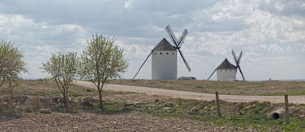 Traditional windmill on field against sky