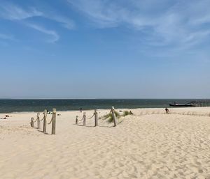 People on beach against sky