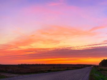 Scenic view of road against sky during sunset