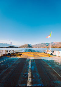 Bridge over river against clear blue sky