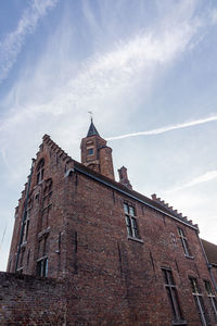 Low angle view of church against cloudy sky