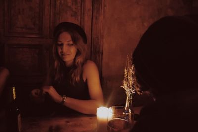 Close-up of young woman sitting on table