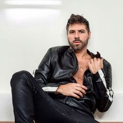 Portrait of young man sitting at home