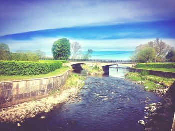 Bridge over river against sky