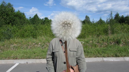 Full length of woman standing by road against sky