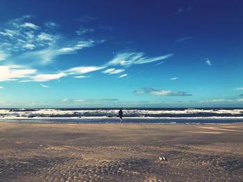 Scenic view of beach against blue sky