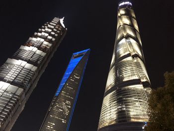 Low angle view of illuminated buildings against sky at night