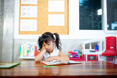 Portrait of a girl sitting on table