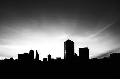 Silhouette of skyscrapers against sky