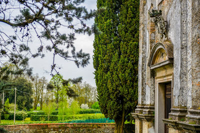 Panoramic view of garden by building against sky