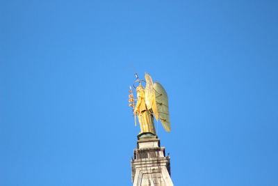 Low angle view of tower against clear blue sky