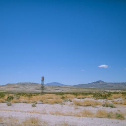 Scenic view of field against clear blue sky