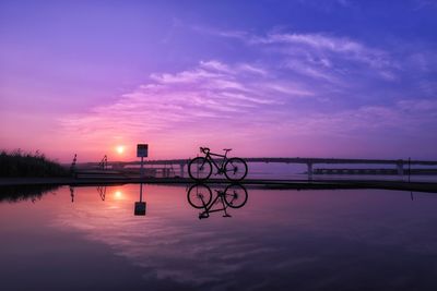 Scenic view of lake against sky at sunset