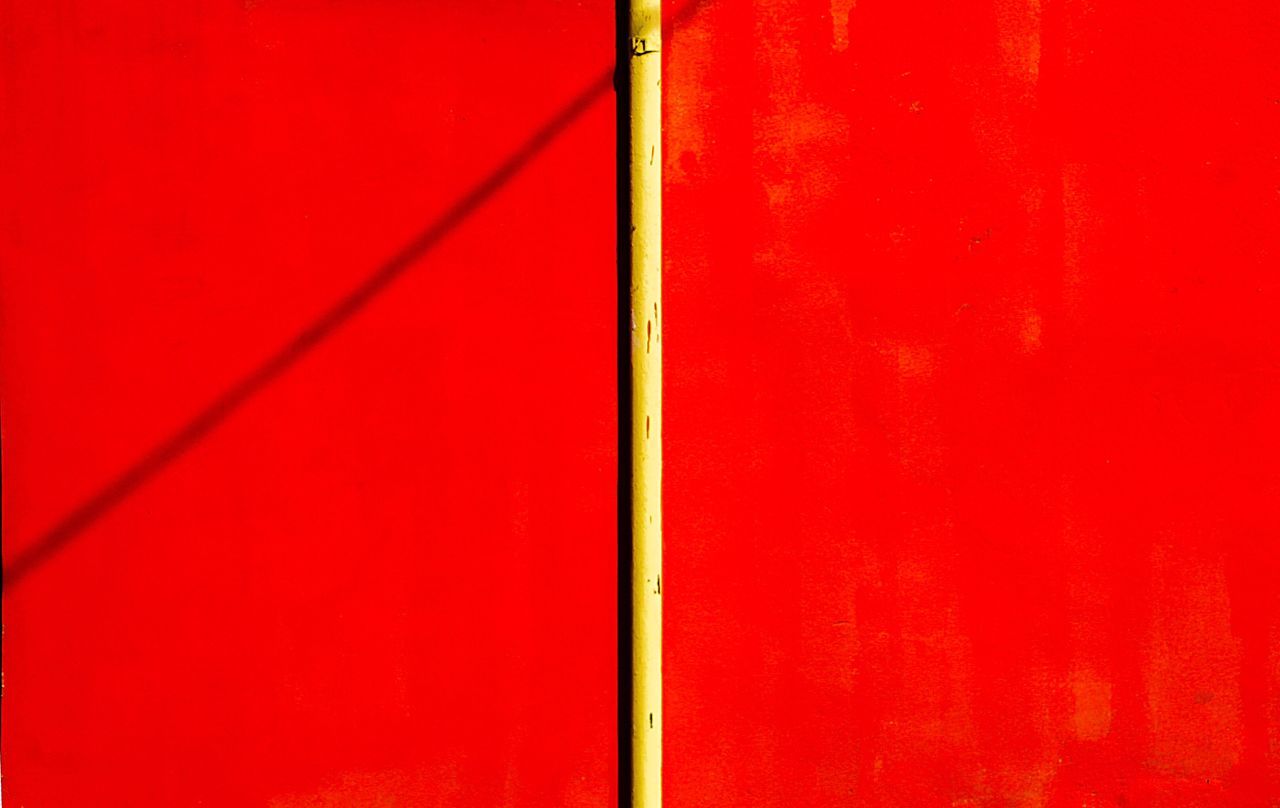 red, full frame, no people, wall - building feature, close-up, backgrounds, day, metal, textured, outdoors, vibrant color, built structure, pole, architecture, pattern, sunlight, line, rod, wall