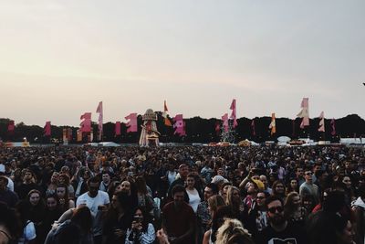 Crowd at concert against sky