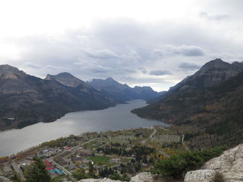 Scenic view of river and mountains against sky