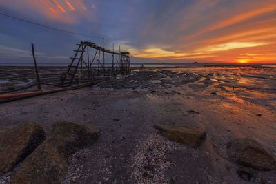 Scenic view of beach against sky during sunset