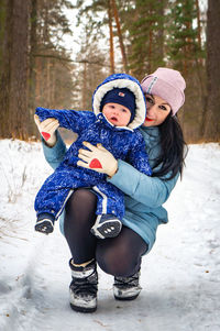 Portrait of boy wearing hat in snow