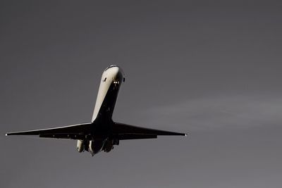 Low angle view of airplane flying against clear sky