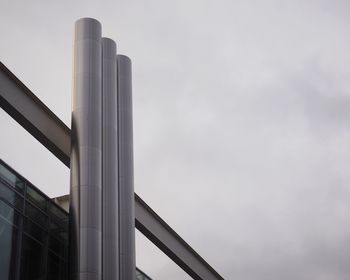 Low angle view of chimneys on building against sky