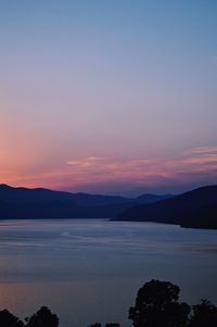 Scenic view of lake against romantic sky at sunset