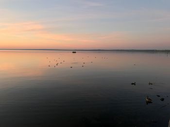 Scenic view of lake against sky during sunset