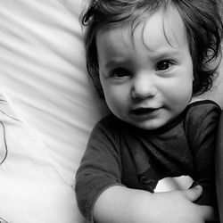 Portrait of cute baby girl on bed