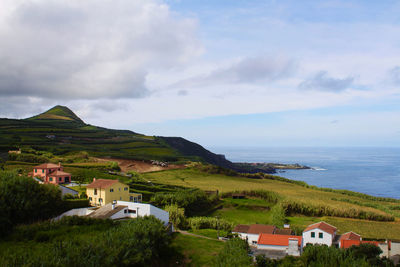 Scenic view of sea and buildings against sky