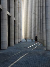 Rear view of woman walking on footpath