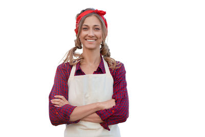 Portrait of a smiling young woman against white background