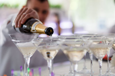 Close-up of bartender serving champagne