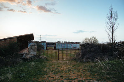 Abandoned building on field against sky