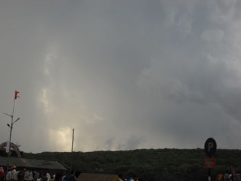 People on land against sky