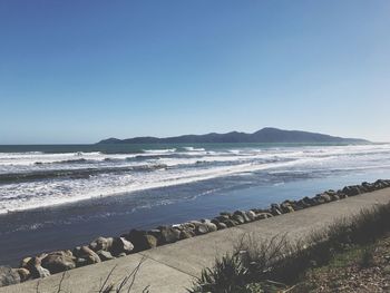 Scenic view of beach against clear sky