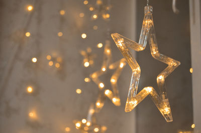 Christmas and new year shining decorations near the window in the shape of stars