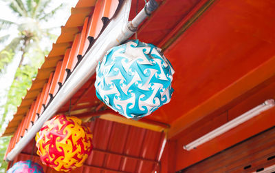 Low angle view of lanterns hanging on wood