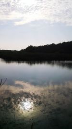 Scenic view of calm lake against sky