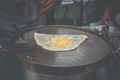 Midsection of person preparing food in kitchen