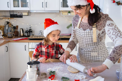 Portrait of smiling friends in kitchen