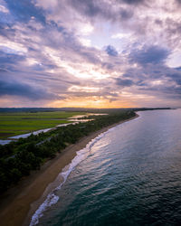 Scenic view of beach against sky during sunset